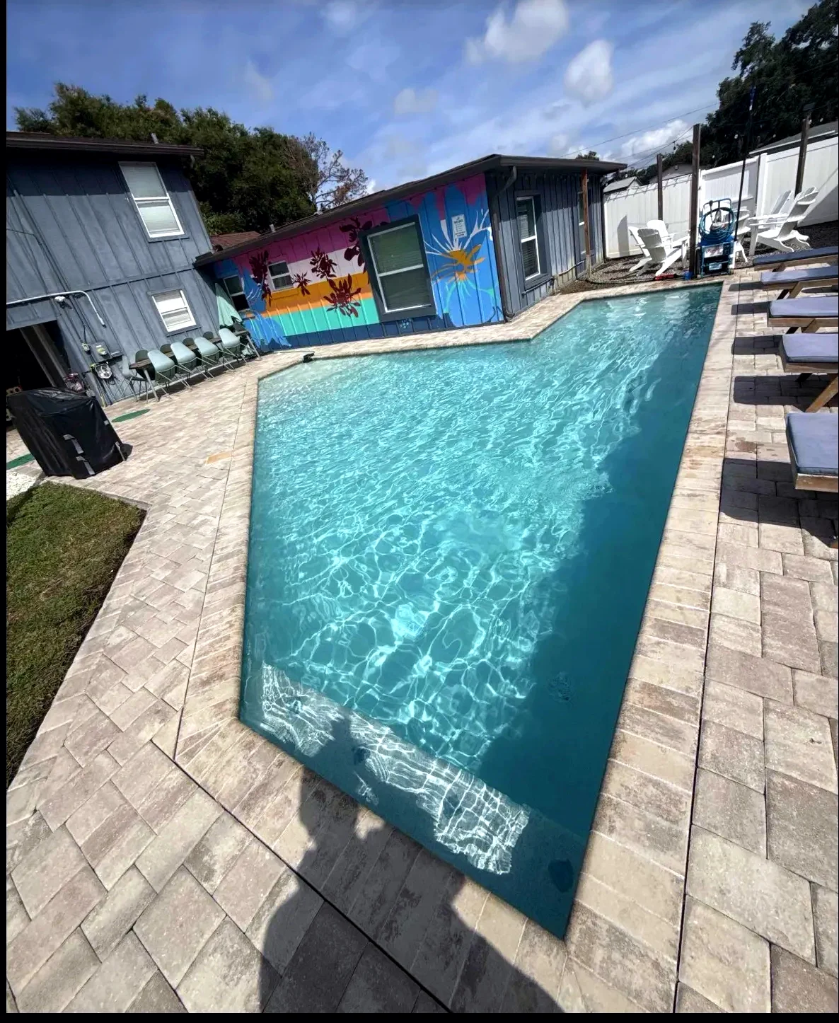 Sparkling clear vacation rental pool at a colorful Pinellas County property serviced by Point of Pines Pools